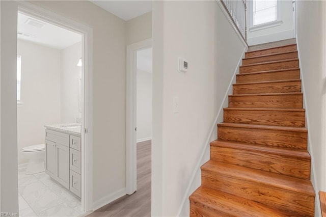 stairway with hardwood / wood-style flooring