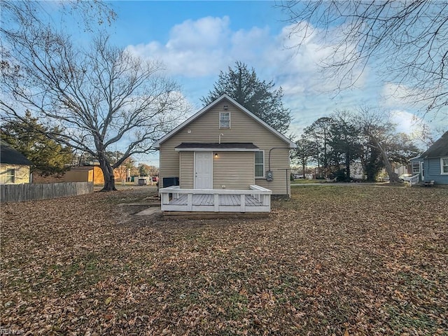 back of house featuring a wooden deck