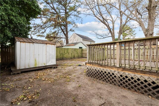 view of yard featuring a shed and a wooden deck