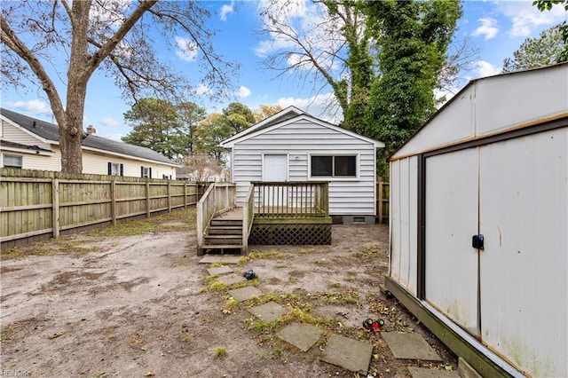 exterior space featuring a storage unit and a wooden deck