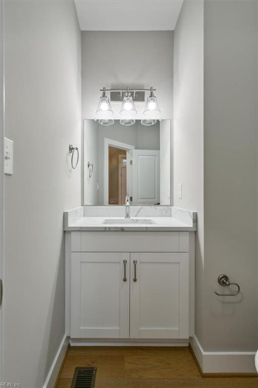 bathroom featuring hardwood / wood-style floors and vanity