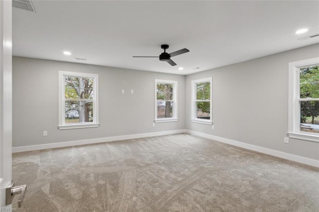 spare room with light carpet and ceiling fan