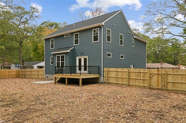 back of house featuring a wooden deck and french doors