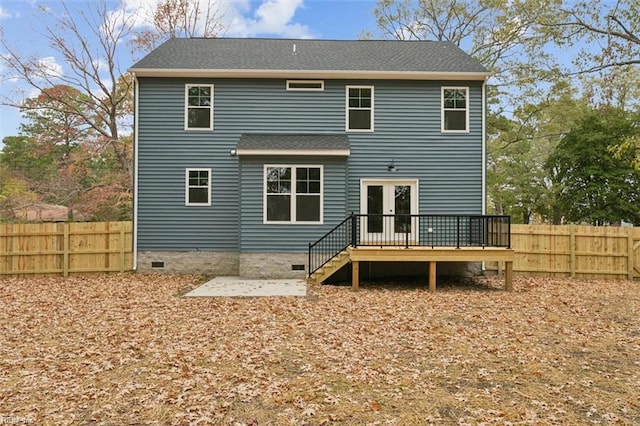 rear view of property featuring a wooden deck, french doors, and a patio