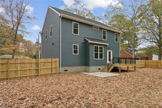 back of property with a patio area and a wooden deck