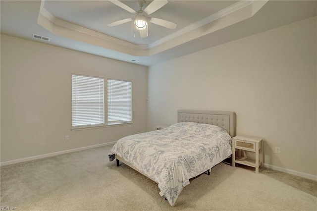 bedroom featuring light carpet, a raised ceiling, ceiling fan, and crown molding