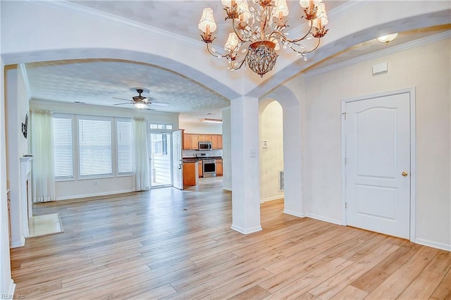 unfurnished living room with ceiling fan with notable chandelier, light wood-type flooring, and crown molding