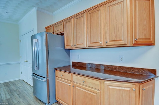 kitchen featuring stainless steel fridge, light hardwood / wood-style flooring, and crown molding