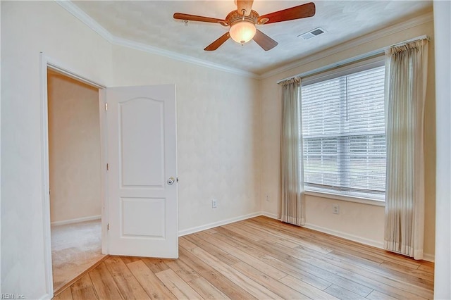 empty room with crown molding, light hardwood / wood-style flooring, and ceiling fan