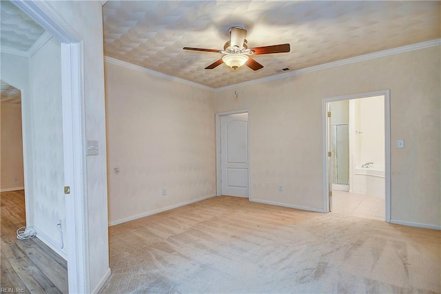 carpeted empty room featuring ceiling fan and ornamental molding