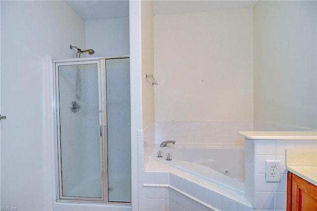 bathroom with vanity and shower with separate bathtub