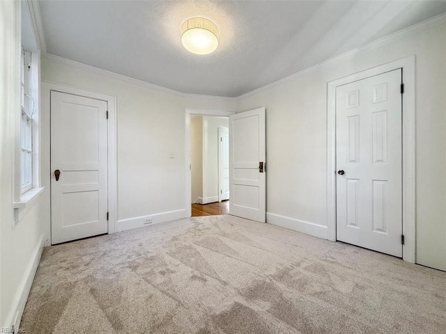 unfurnished bedroom featuring light colored carpet and ornamental molding