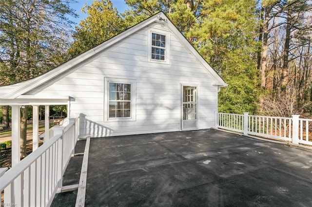 back of property featuring a wooden deck