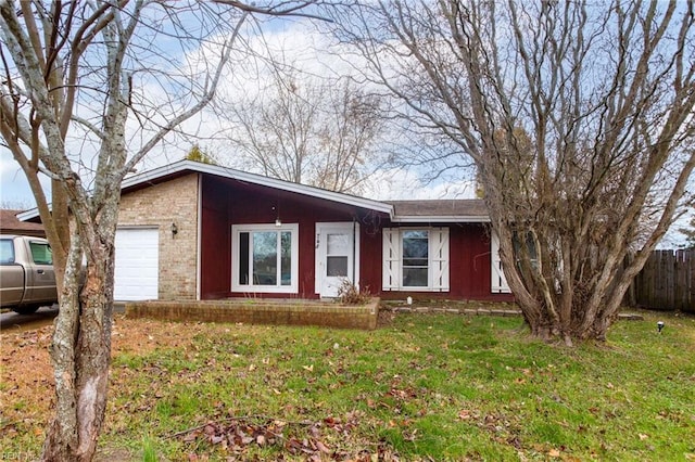 single story home featuring a front lawn and a garage