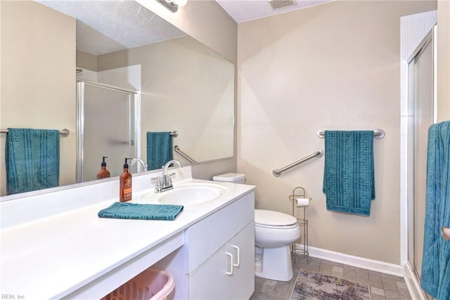 bathroom with vanity, a textured ceiling, toilet, and walk in shower