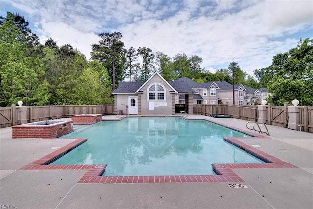 view of pool with a patio area and an outbuilding