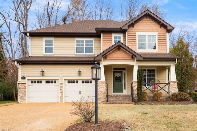 craftsman-style house with a porch, a garage, and a front lawn