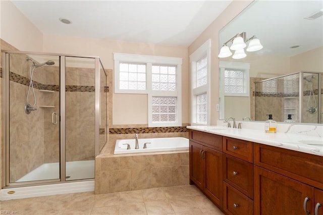 bathroom with tile patterned floors, vanity, and independent shower and bath