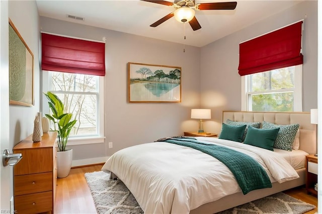 bedroom with ceiling fan and light hardwood / wood-style floors