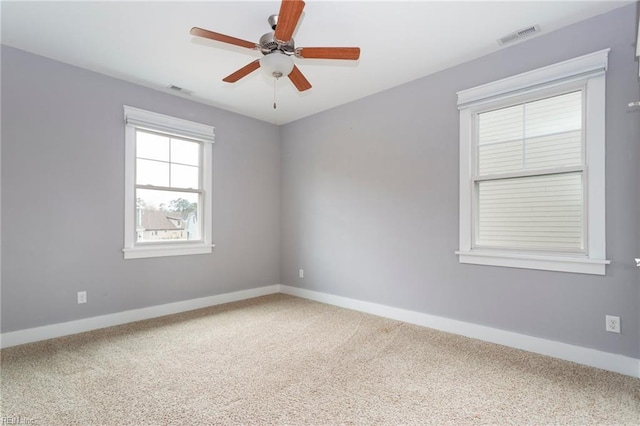 carpeted spare room with ceiling fan