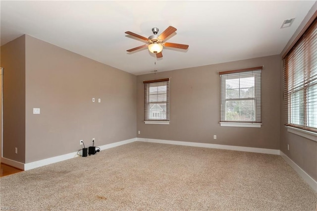 empty room with light colored carpet and ceiling fan