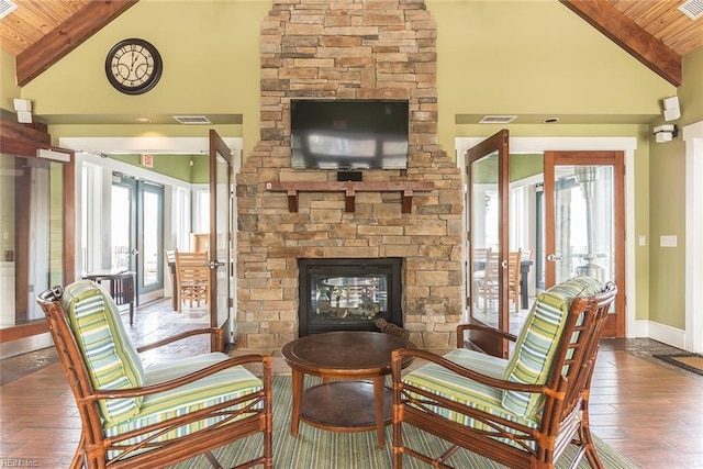 living area featuring plenty of natural light, wooden ceiling, and french doors