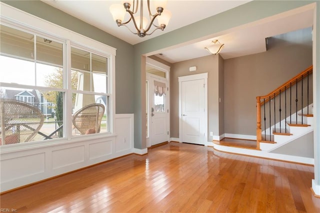 foyer entrance featuring a notable chandelier and light wood-type flooring