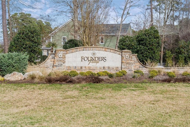 community / neighborhood sign with a lawn