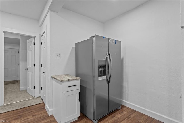 kitchen with white cabinetry, dark hardwood / wood-style flooring, and stainless steel fridge with ice dispenser