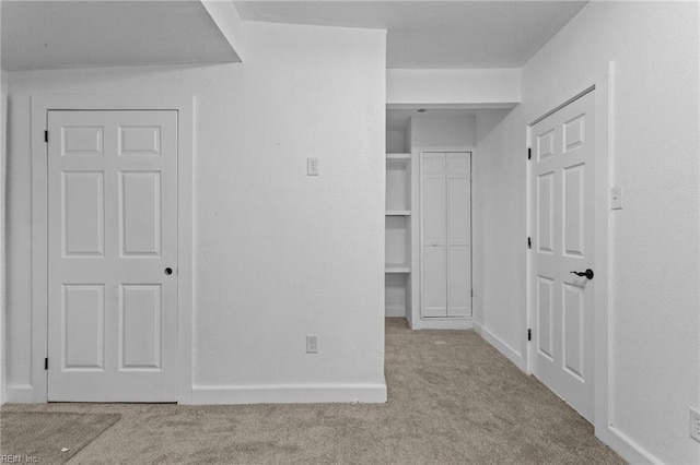 unfurnished bedroom featuring light carpet