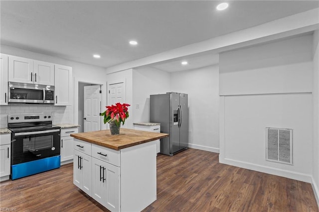 kitchen featuring white cabinets, appliances with stainless steel finishes, and backsplash