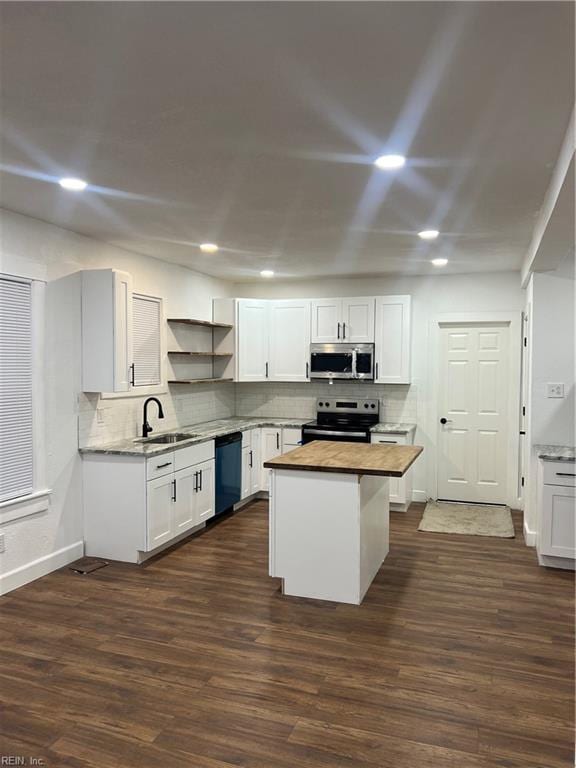 kitchen featuring wooden counters, appliances with stainless steel finishes, sink, white cabinets, and dark hardwood / wood-style floors