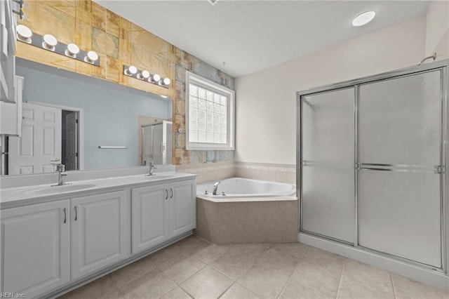 bathroom featuring tile patterned floors, vanity, and shower with separate bathtub