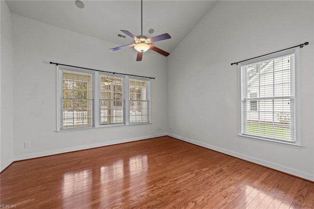 spare room with light hardwood / wood-style floors, high vaulted ceiling, and ceiling fan