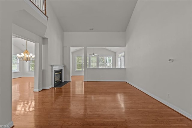 4756 Winterberry Ct, Williamsburg, VA 23188 - unfurnished living room with wood finished floors, a chandelier, and a fireplace with flush hearth