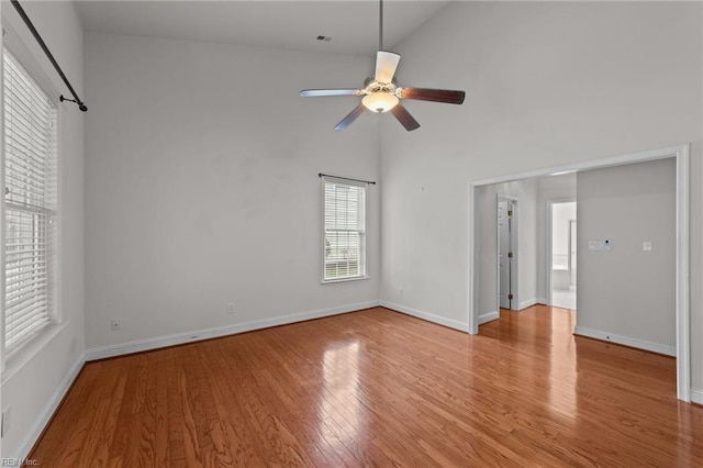 spare room featuring light hardwood / wood-style flooring, high vaulted ceiling, and ceiling fan