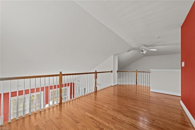 additional living space with ceiling fan, hardwood / wood-style floors, and vaulted ceiling