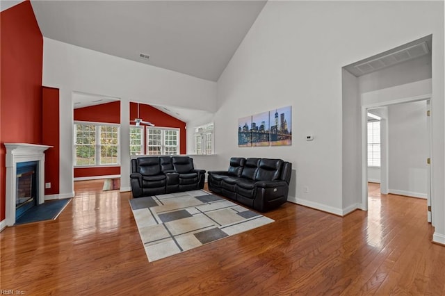 living room with hardwood / wood-style flooring and high vaulted ceiling