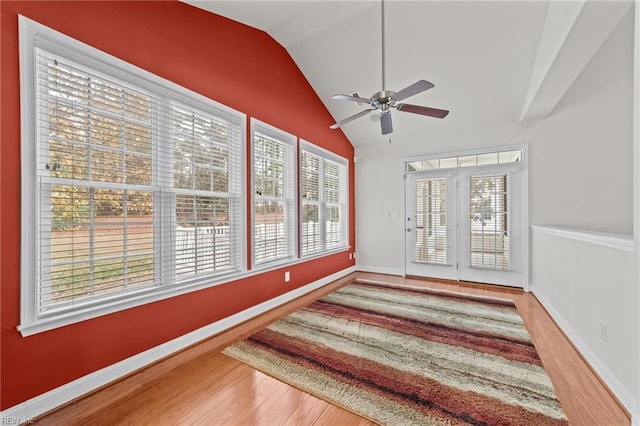 sunroom / solarium with ceiling fan and vaulted ceiling