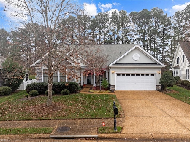 view of front of home with a garage and a front lawn