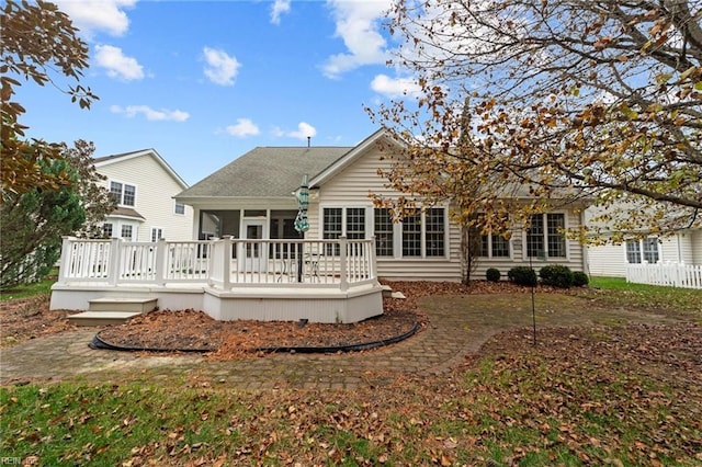 rear view of house featuring a deck