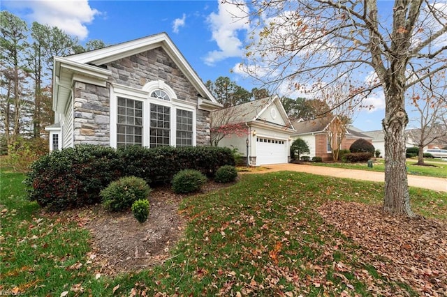 view of front of property with a front yard and a garage