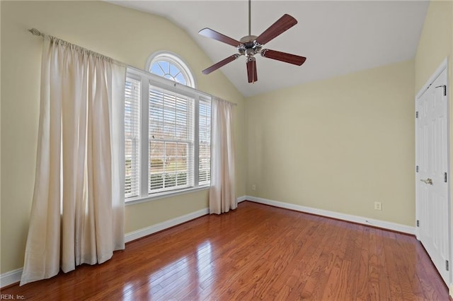 unfurnished room featuring ceiling fan, vaulted ceiling, and light wood-type flooring