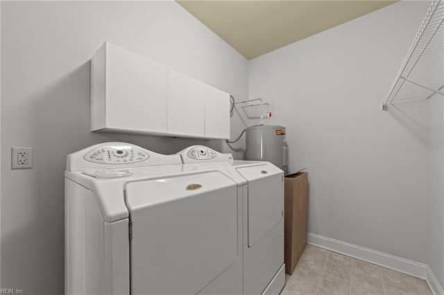 washroom with separate washer and dryer, electric water heater, light tile patterned floors, and cabinets