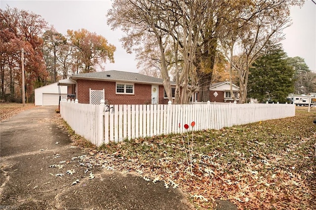 exterior space with a garage and an outdoor structure