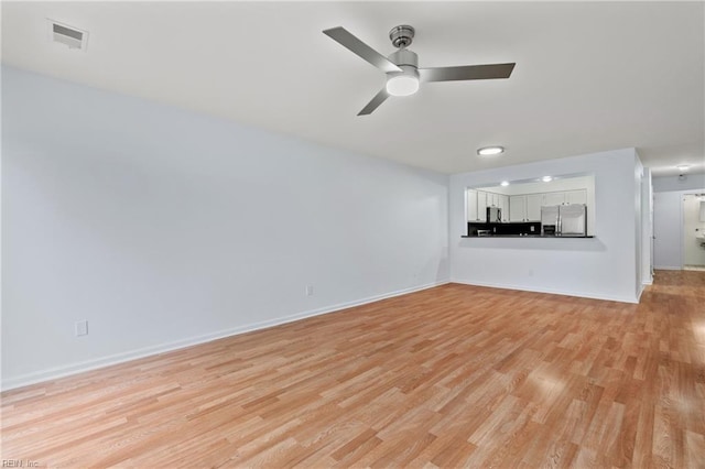 unfurnished living room with light hardwood / wood-style floors and ceiling fan