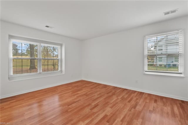 spare room with light hardwood / wood-style floors