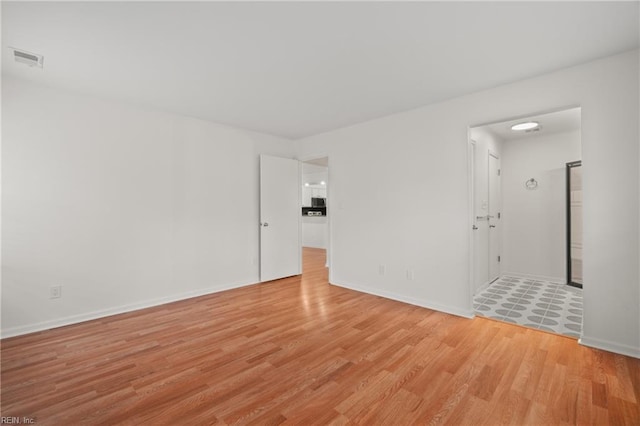 unfurnished room with light hardwood / wood-style floors