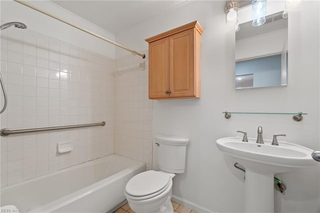 full bathroom with tile patterned flooring, toilet, tiled shower / bath, and sink