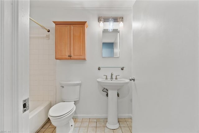 bathroom with tile patterned flooring, tiled shower / bath combo, and toilet